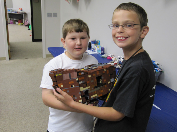 two kids holding legos